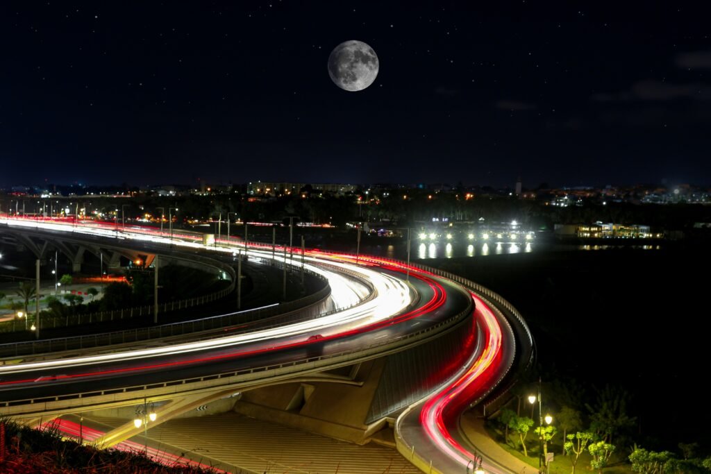 a long exposure photo of a highway at night